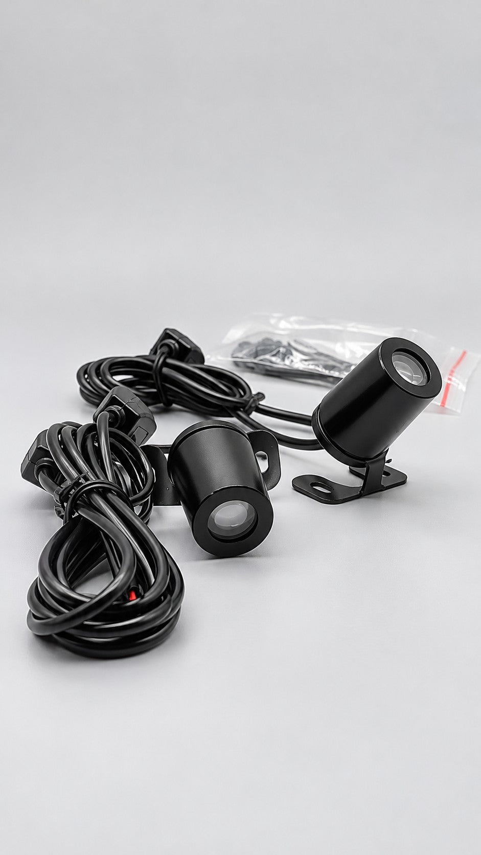 Two black Shadowride projectors with brackets, wiring and supplied hardware